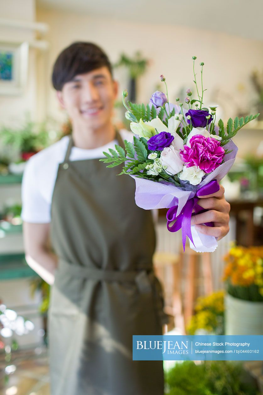Male Chinese florist holding flower bouquet