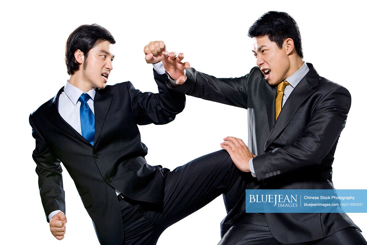 Two Chinese businessmen fighting on white background