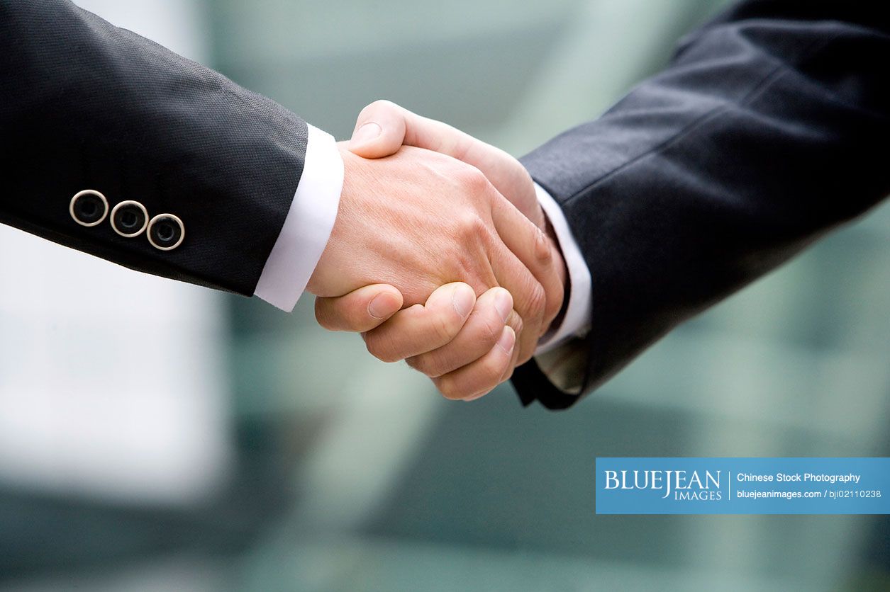 Close-up of Chinese businessmen shaking hands