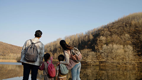 Cheerful young Chinese family enjoying the beautiful natural scenery