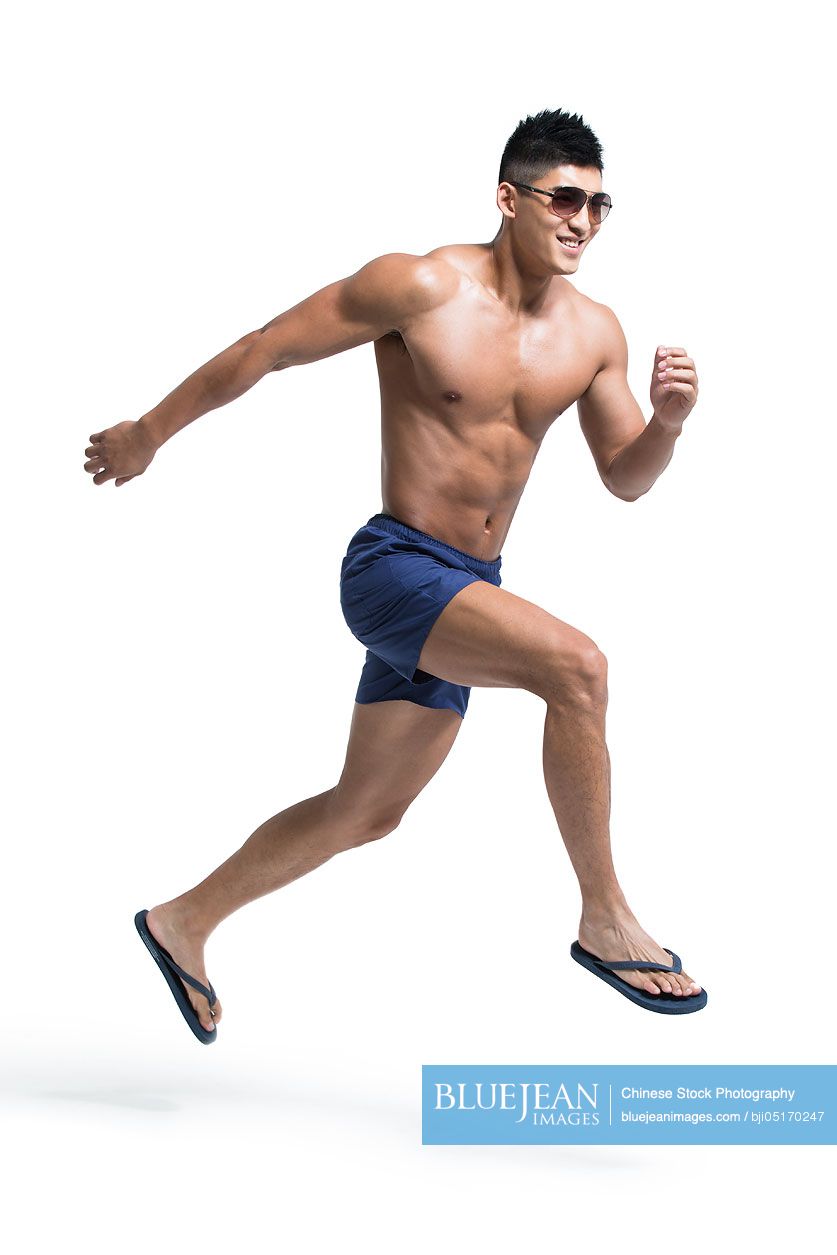 Young Chinese muscular man running