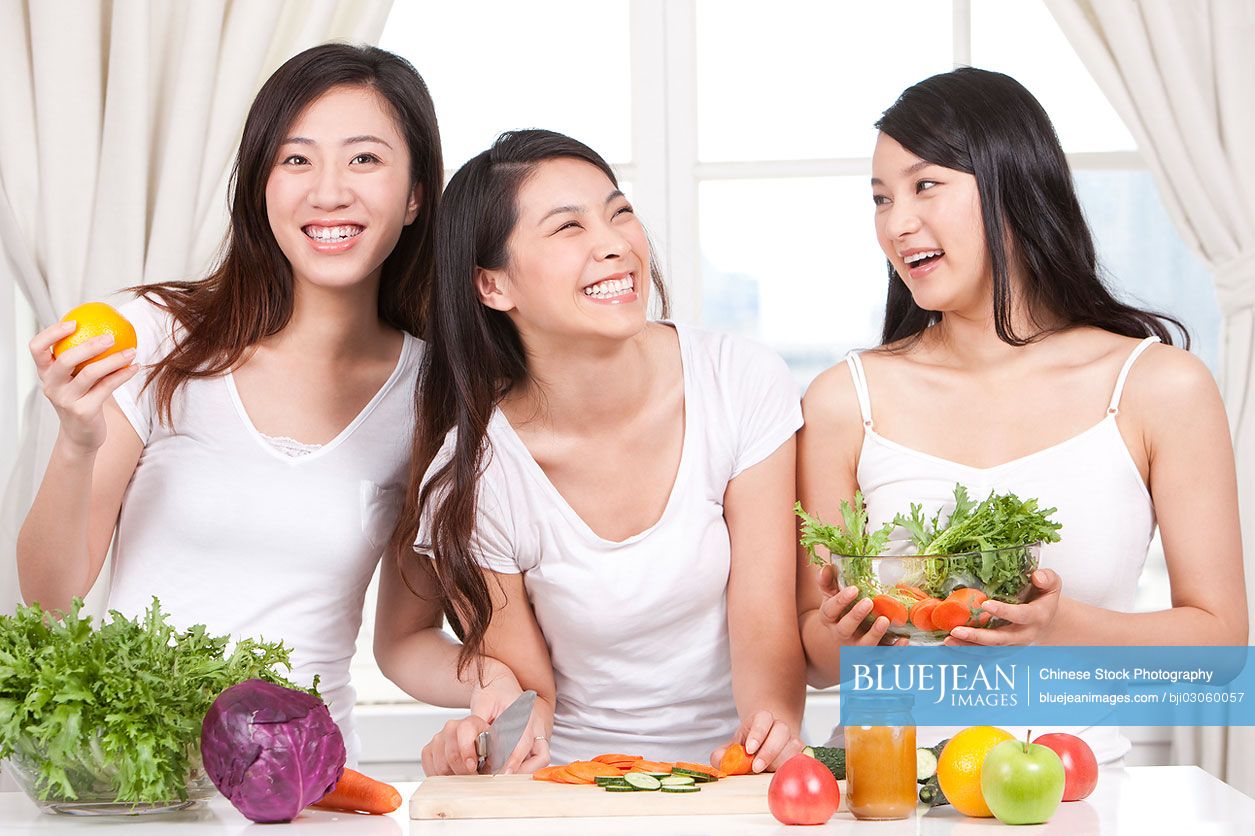 Best female Chinese friends preparing salad together-High-res stock ...