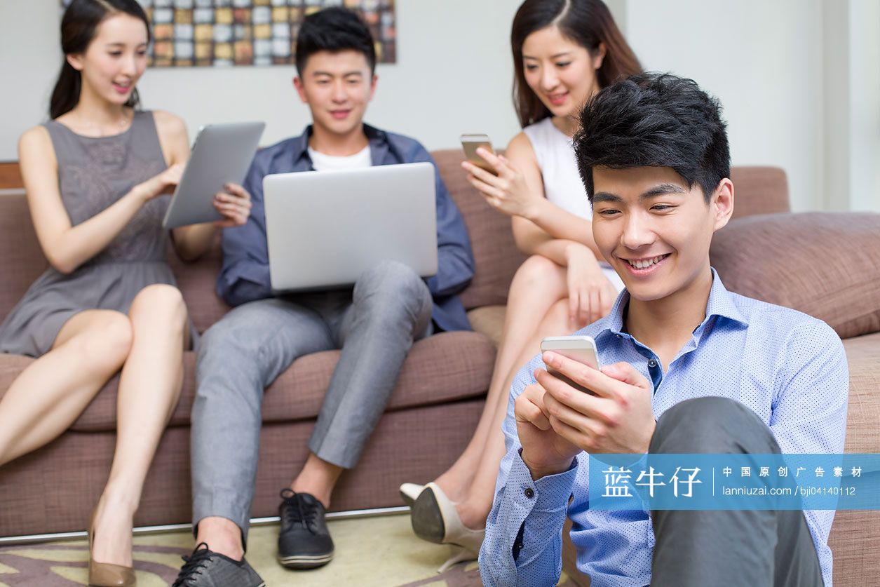 快乐的年轻人玩手机和电脑