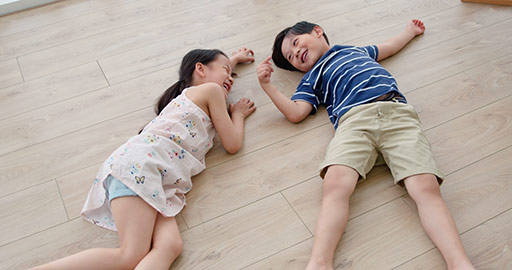 Happy Chinese sibling lying on floor,4K