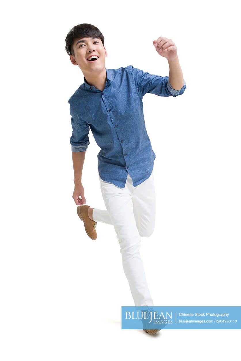 Happy young Chinese man running