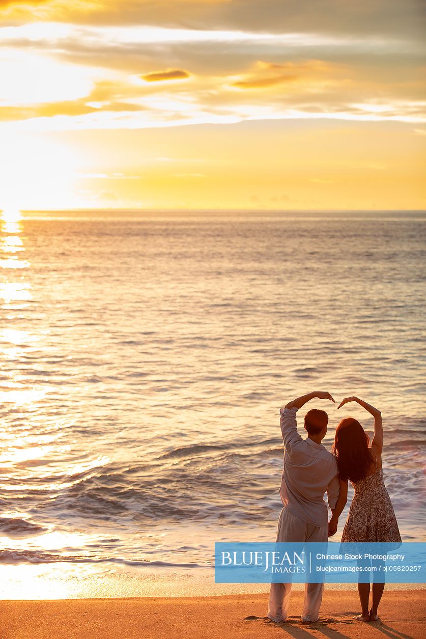 Romantic young Chinese couple on beach