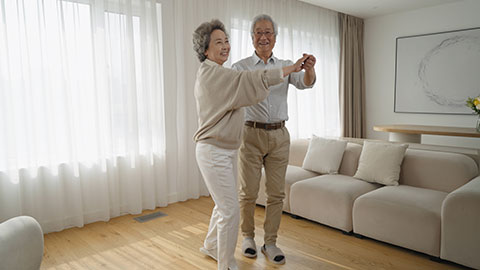 Cheerful senior Chinese couple dancing at home,4K