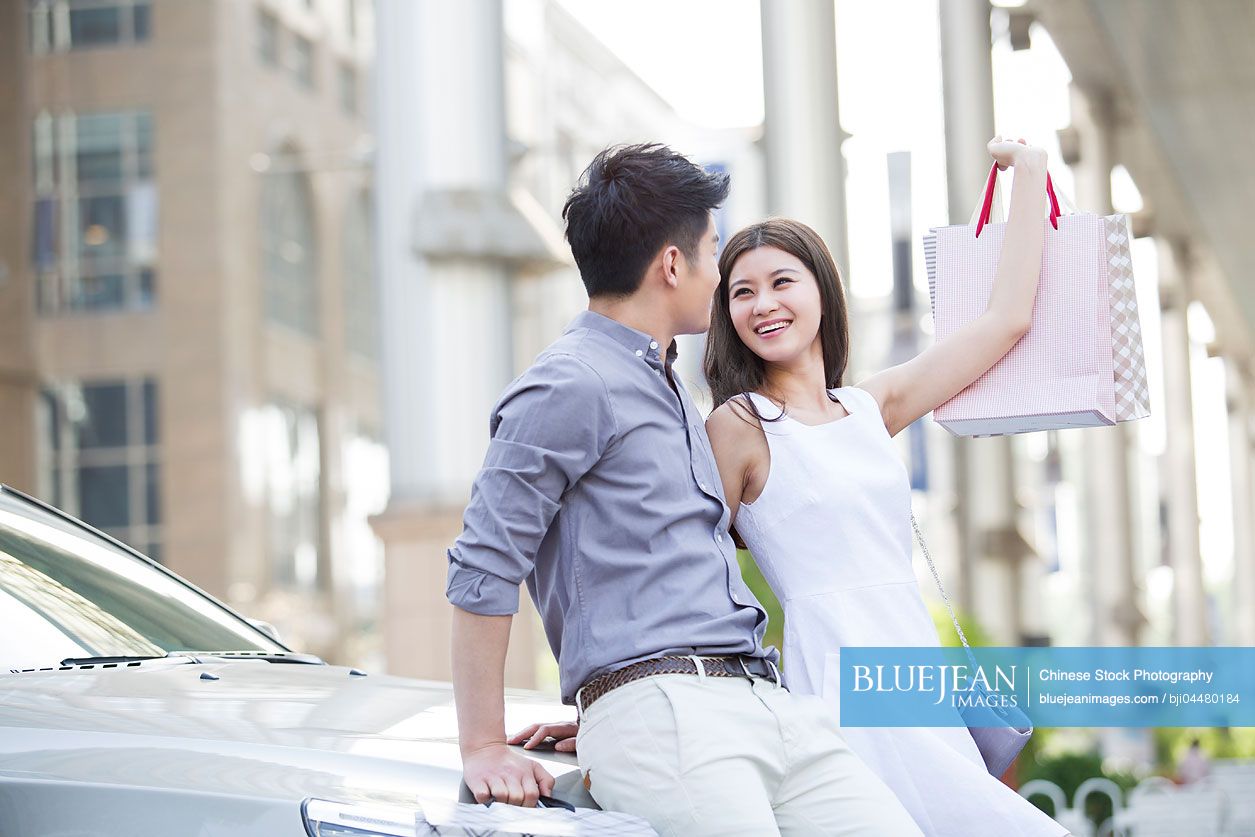 Happy young Chinese couple shopping