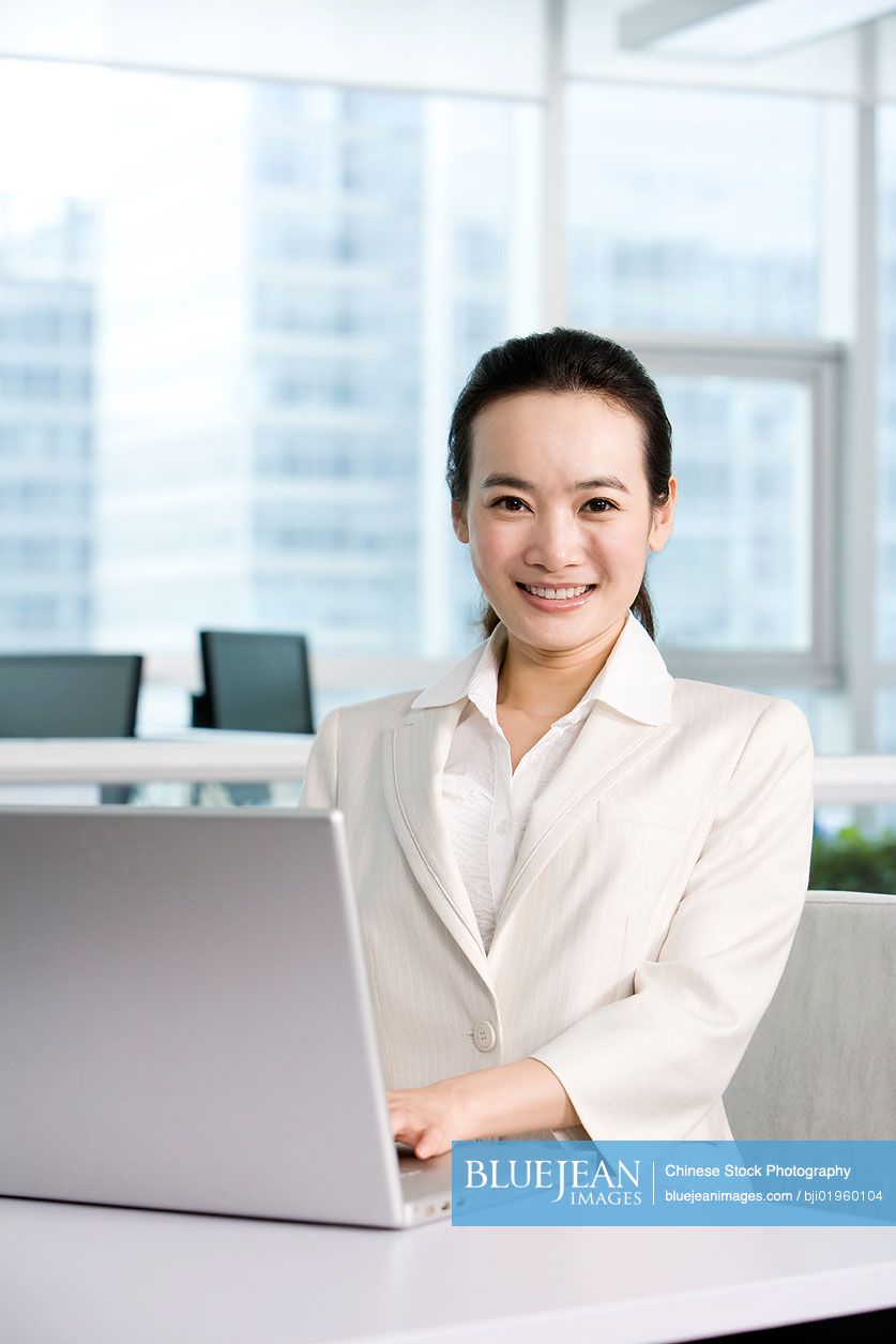 Chinese office worker at her desk