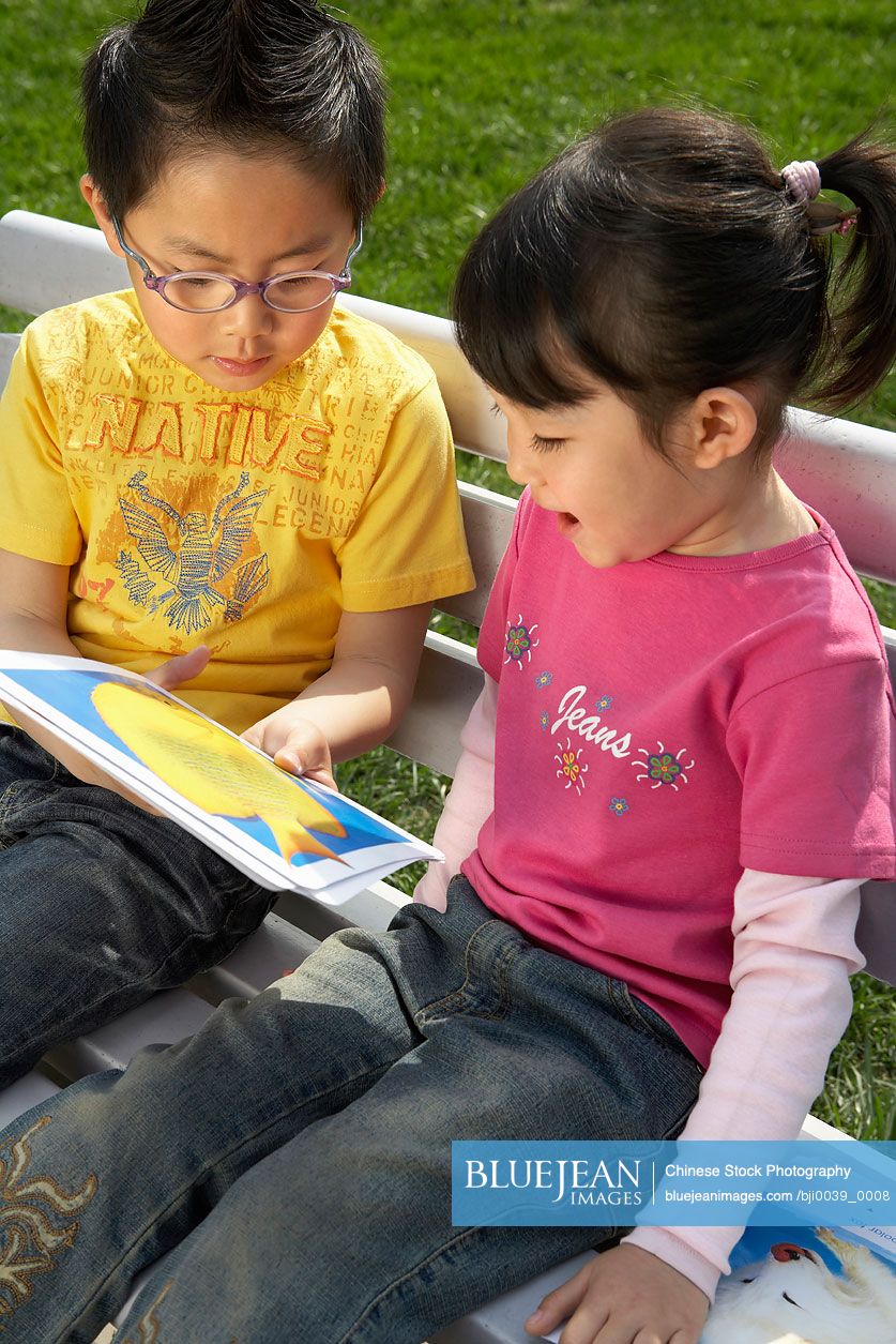 Chinese Children Reading Book Together