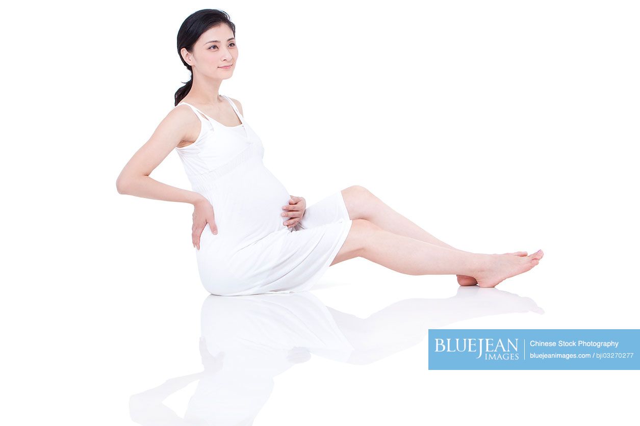 Chinese pregnant woman sitting on floor