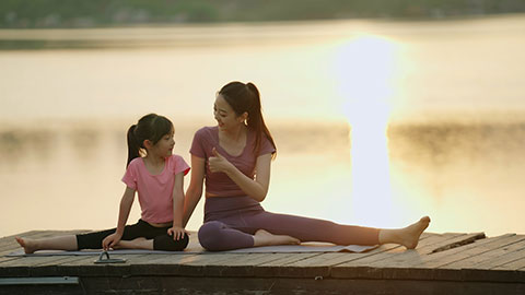 妈妈和女儿在公园练瑜伽