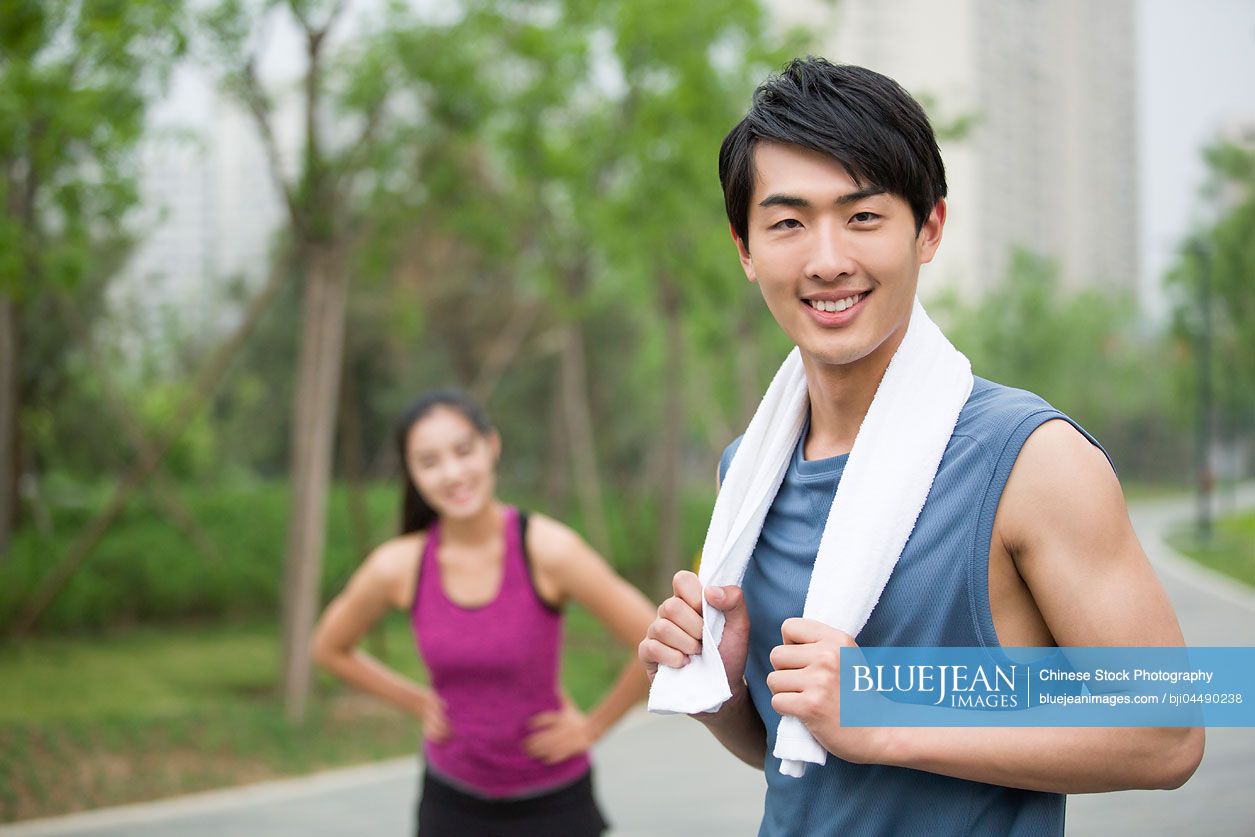 Young Chinese couple taking a break from exercise