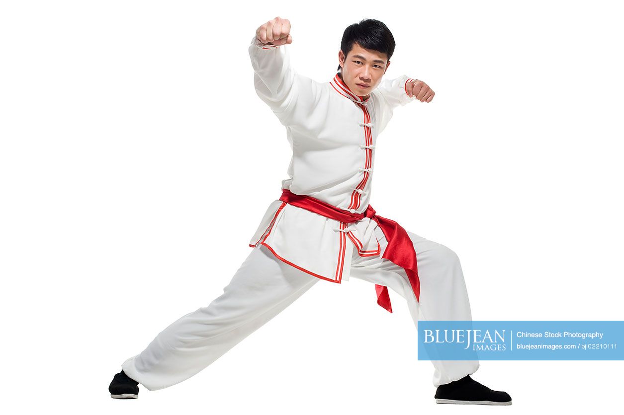 Chinese man in traditional clothing doing martial arts