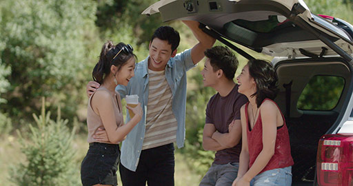 Happy young Chinese friends enjoying road trip,4K