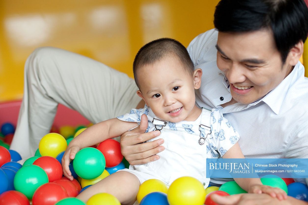 Chinese father playing with son