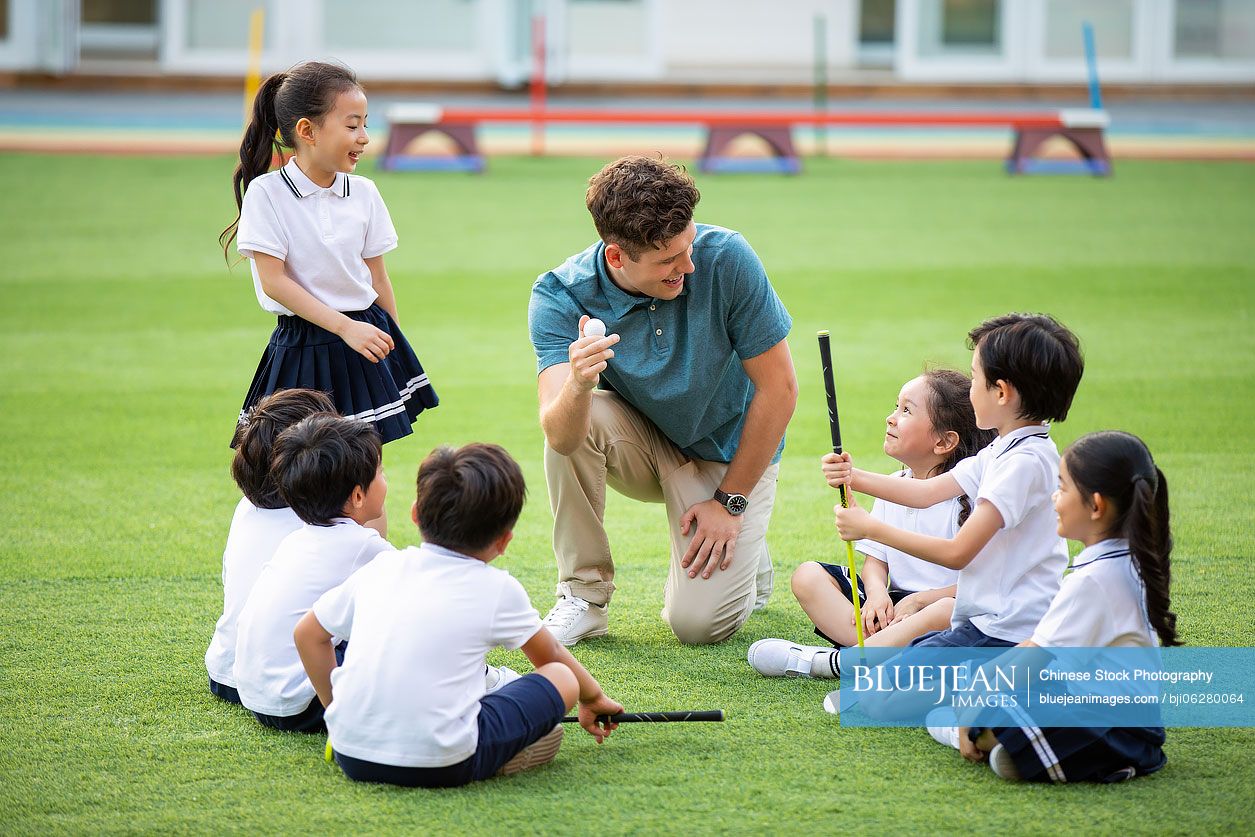 Foreign teacher teaching golf