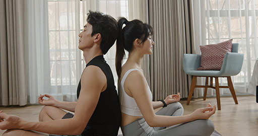 Young Chinese couple doing yoga at home,4K