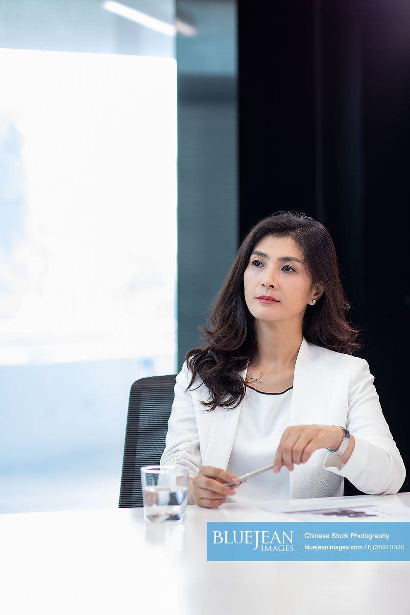 Beautiful Chinese businesswoman in meeting room