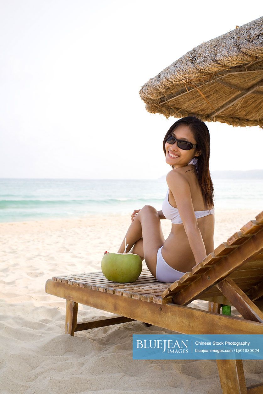 Young Chinese woman relaxing on the beach