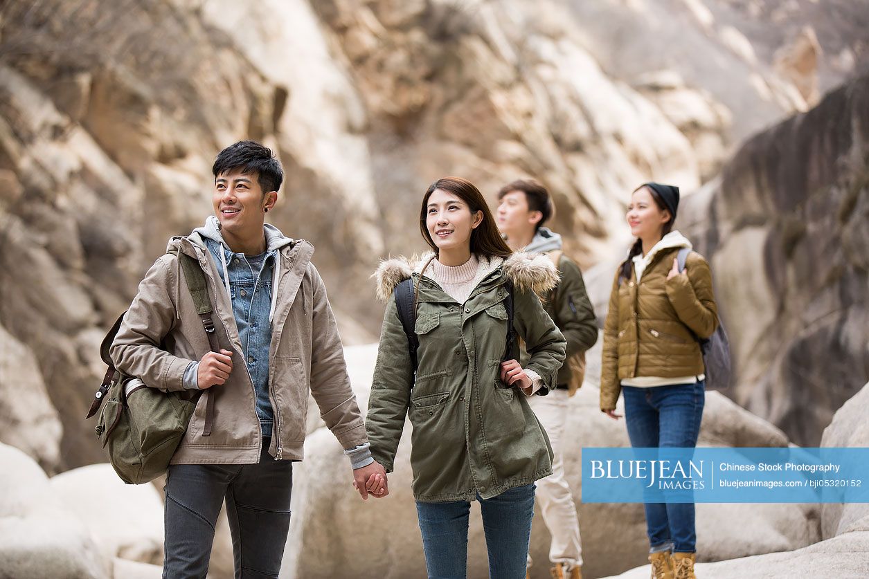 Happy young Chinese friends enjoying winter outing