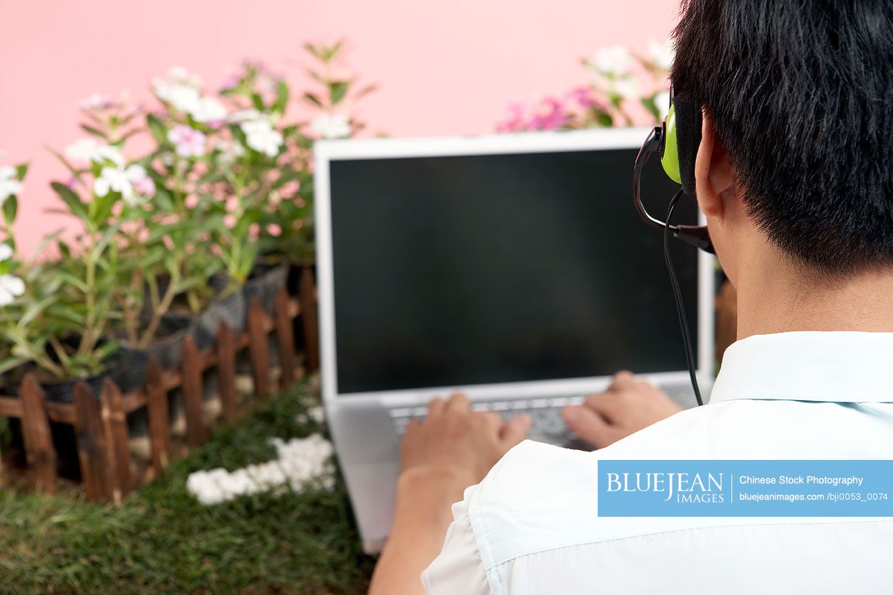 Chinese Businessman Typing On Laptop