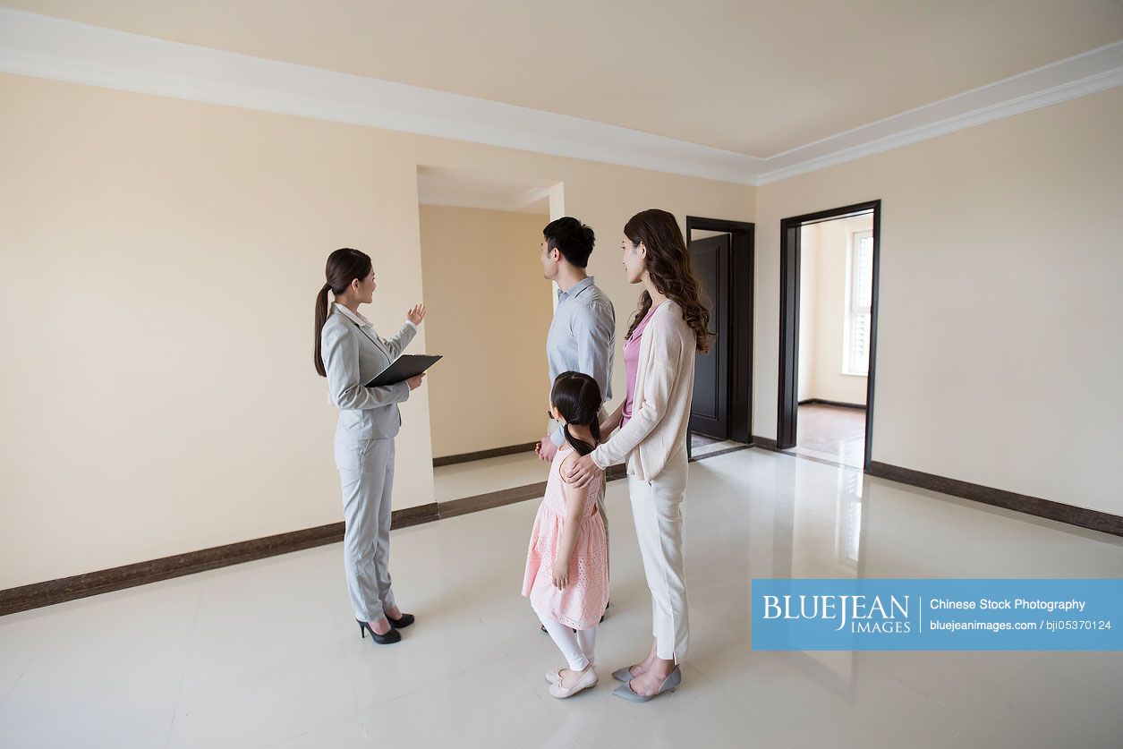 Chinese realtor showing new house to young family