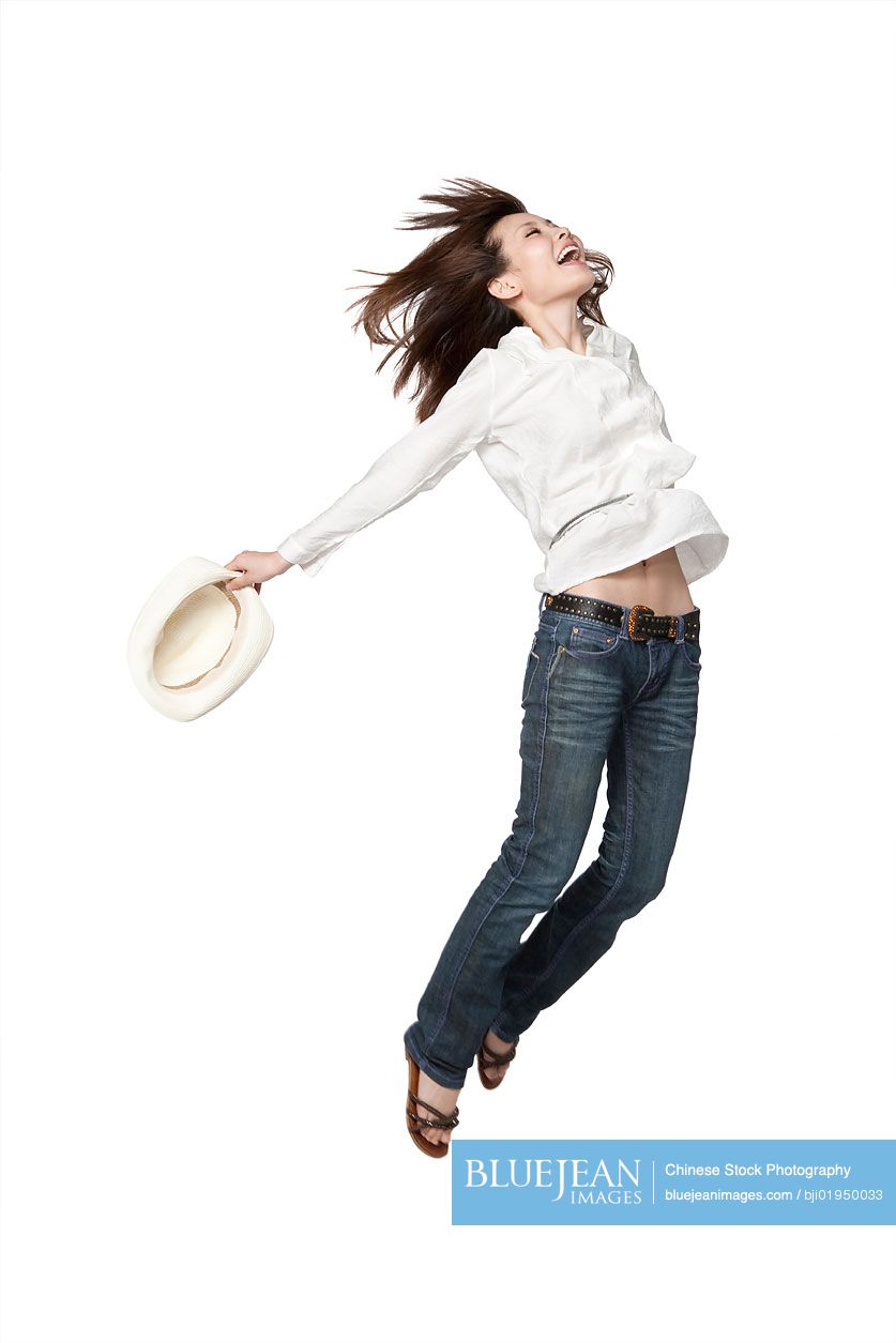 Portrait of young Chinese woman jumping