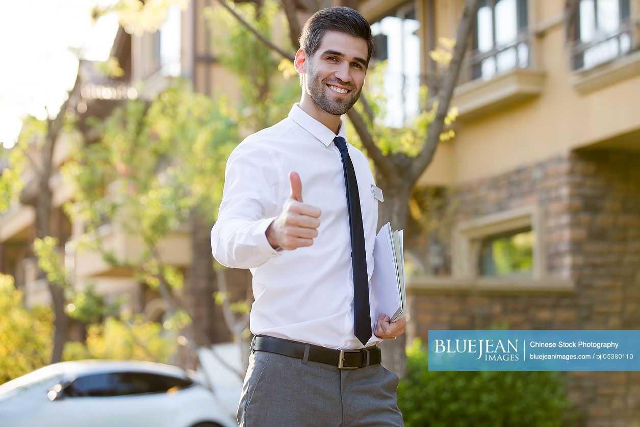 confident-businessman-doing-thumbs-up-high-res-stock-photo-for-download