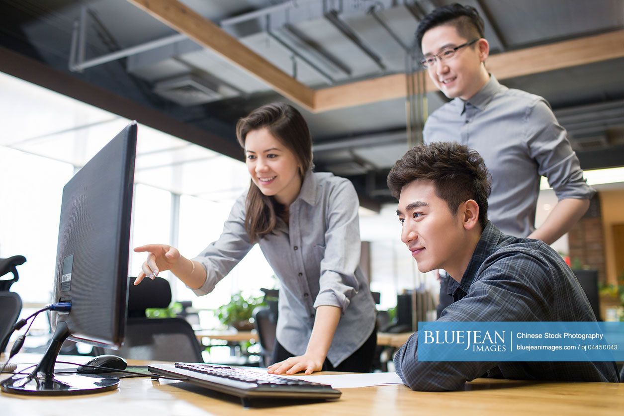 Chinese IT workers talking in office