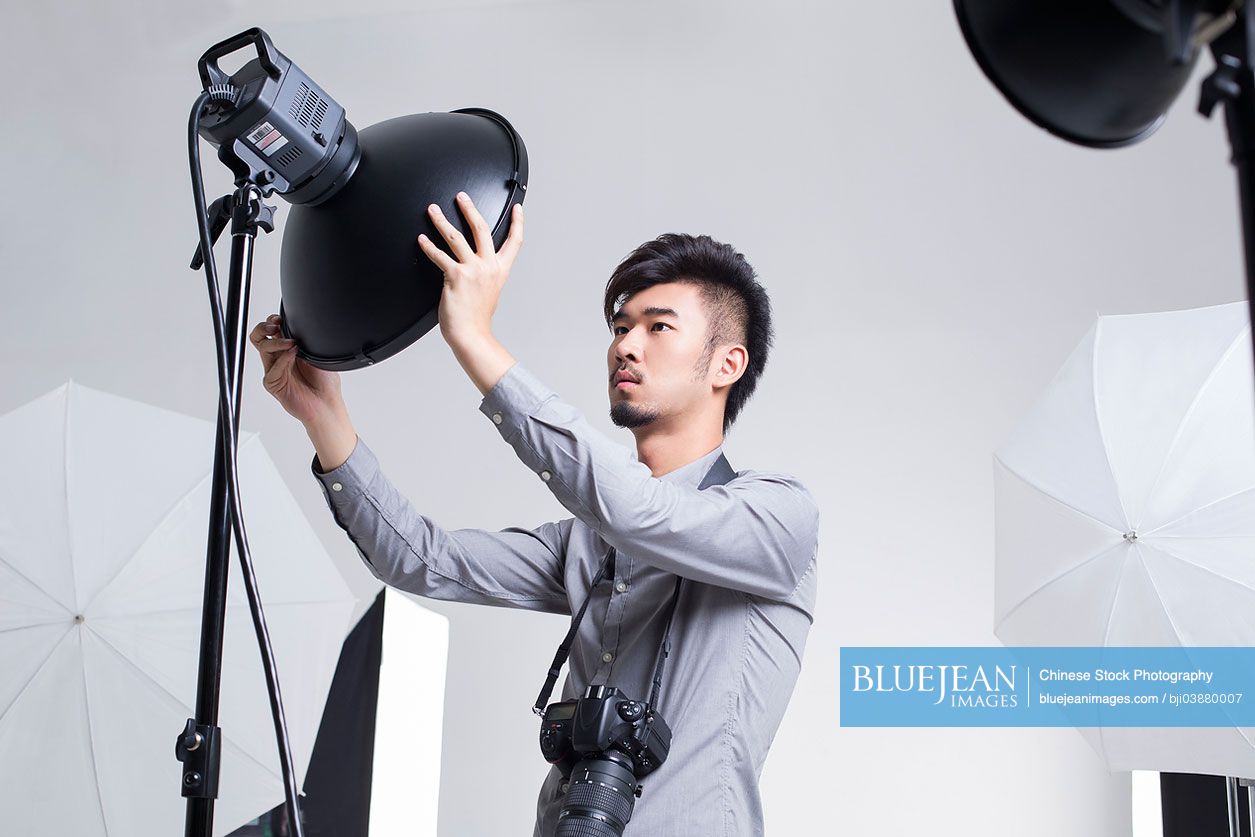 Chinese photographer adjusting radar dome in studio