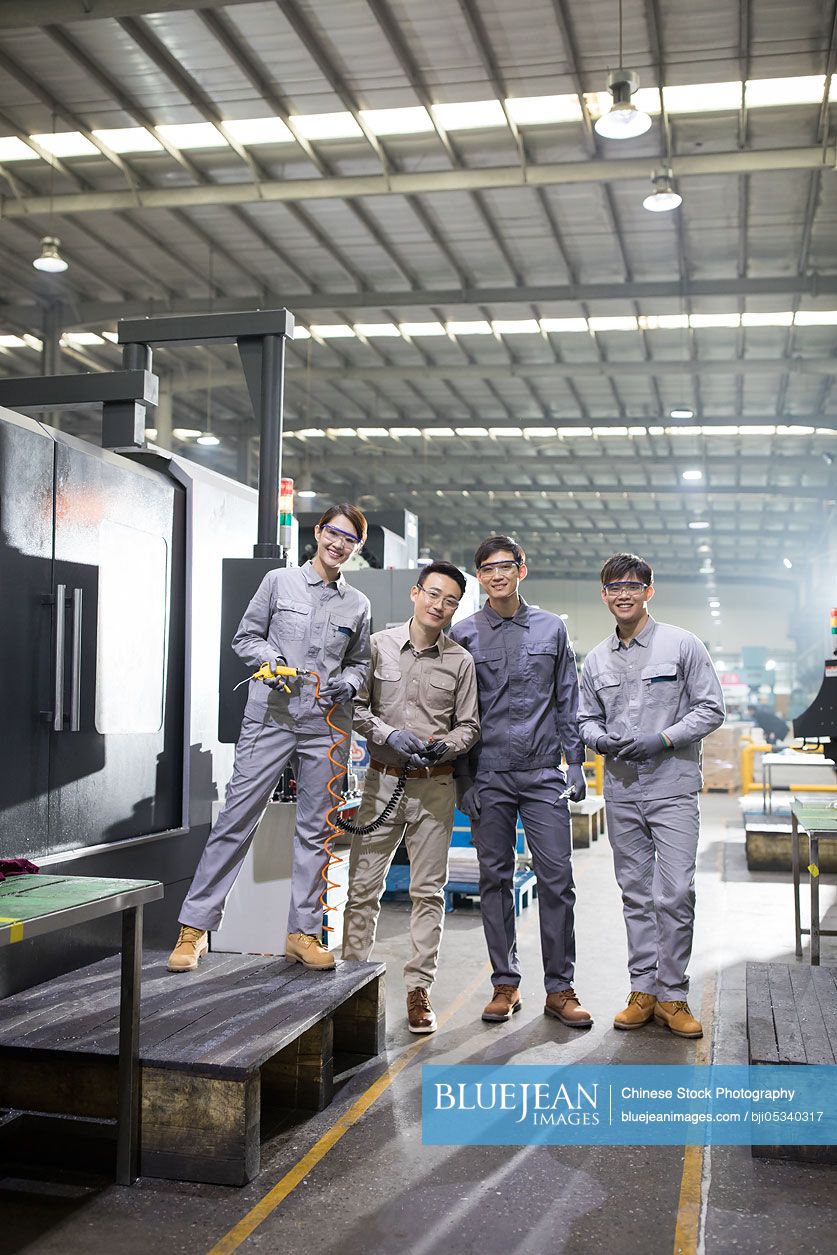 Confident Chinese engineers in the factory