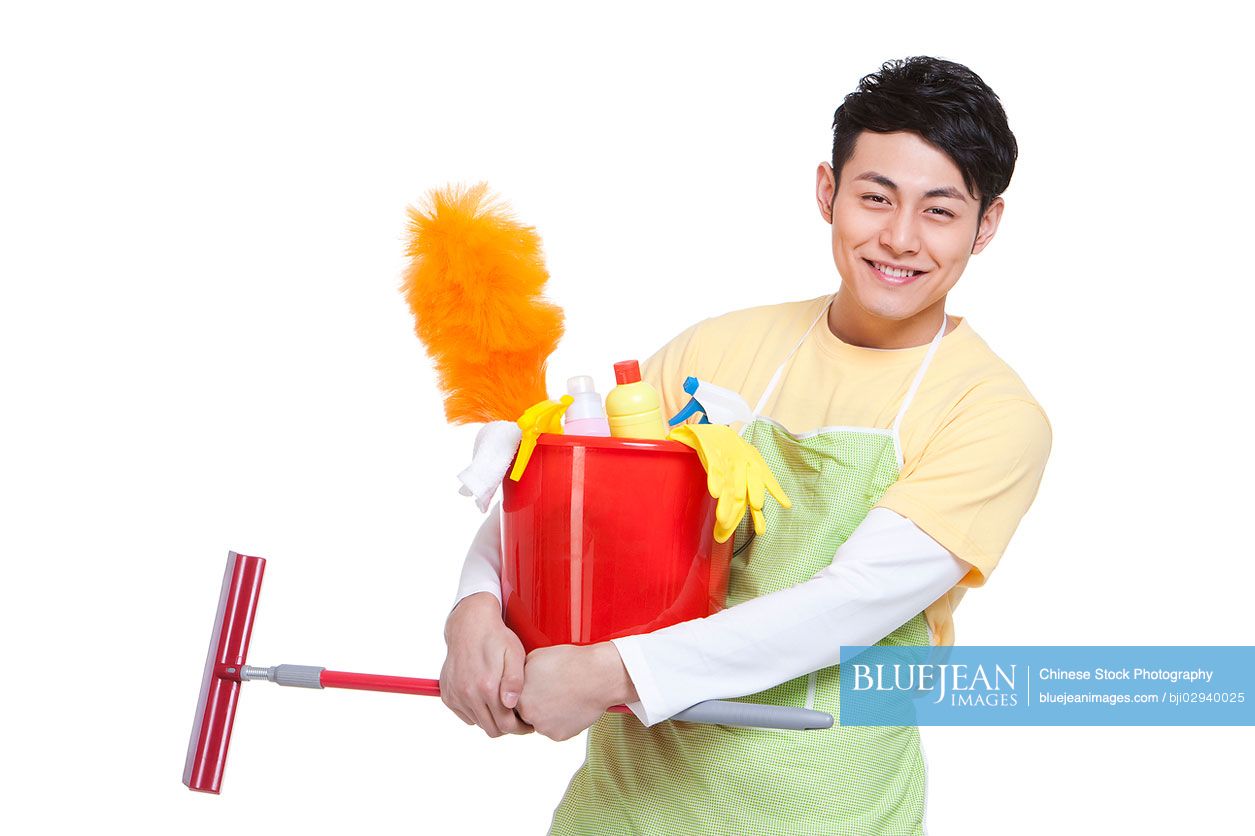 Young Chinese man with cleaning product