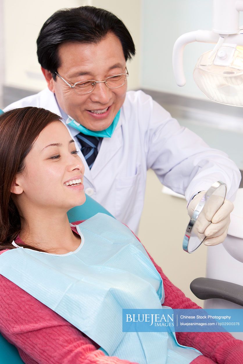 Chinese patient receiving treatment in dental clinicHighres stock