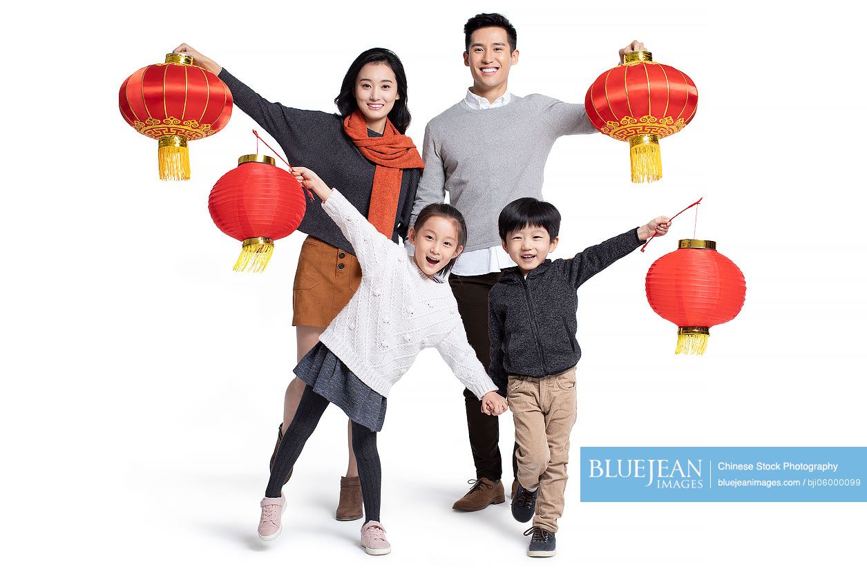 Happy young Chinese family holding lanterns