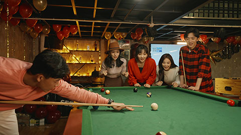 Happy young Chinese friends playing billiard together,4K
