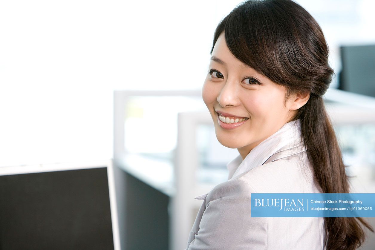 Chinese office worker at her desk