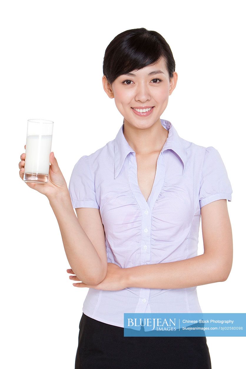 Chinese businesswoman holding a glass of milk