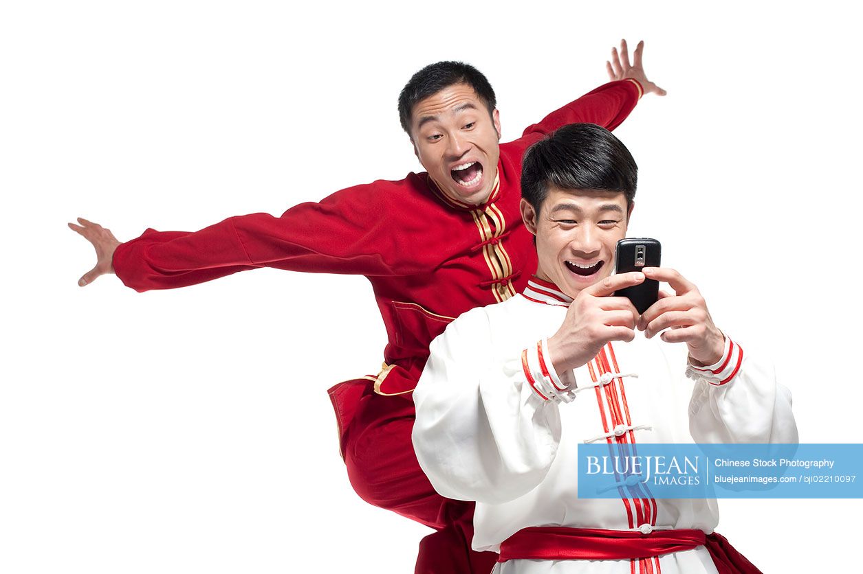 Two Chinese friends looking at a mobile phone