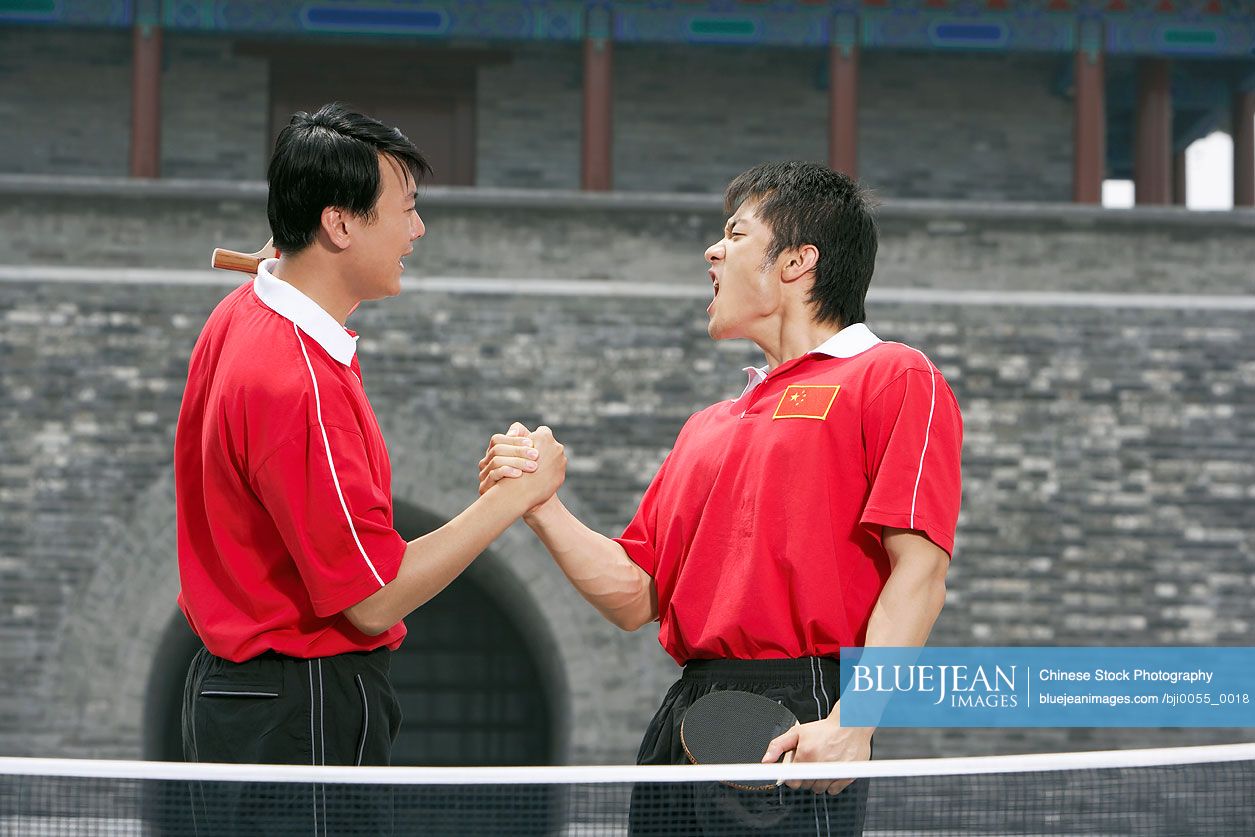 Chinese Ping Pong Players Shaking Hands And Cheering