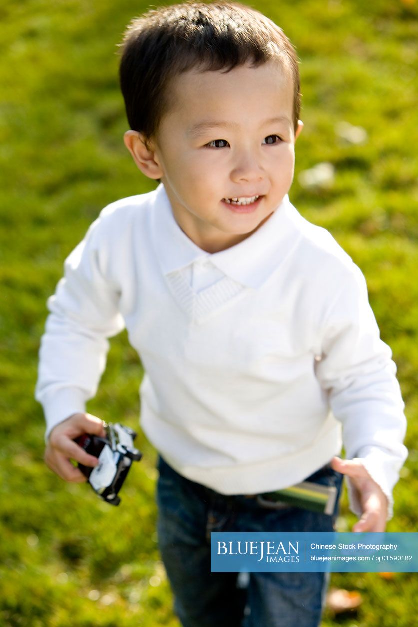 Little Chinese boy playing outside