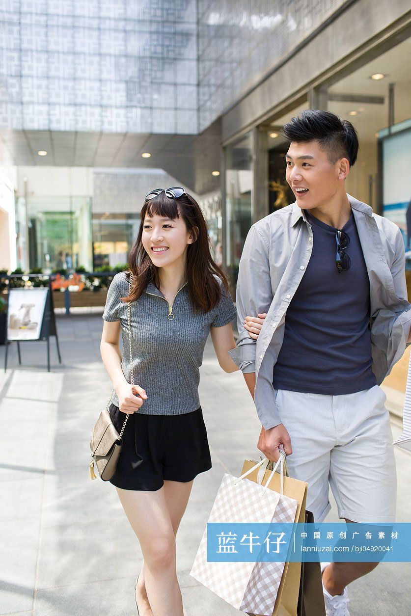 快乐的年轻情侣逛街购物