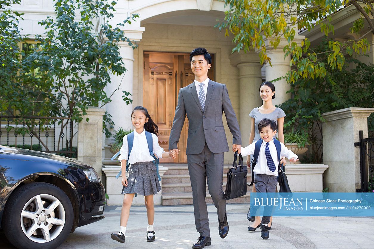Young Chinese couple sending their children to school