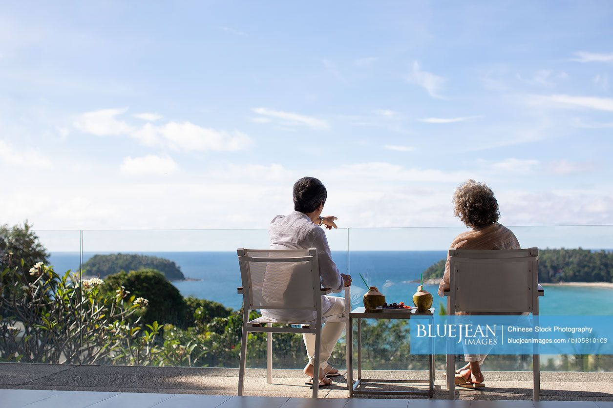 Senior Chinese couple relaxing on balcony