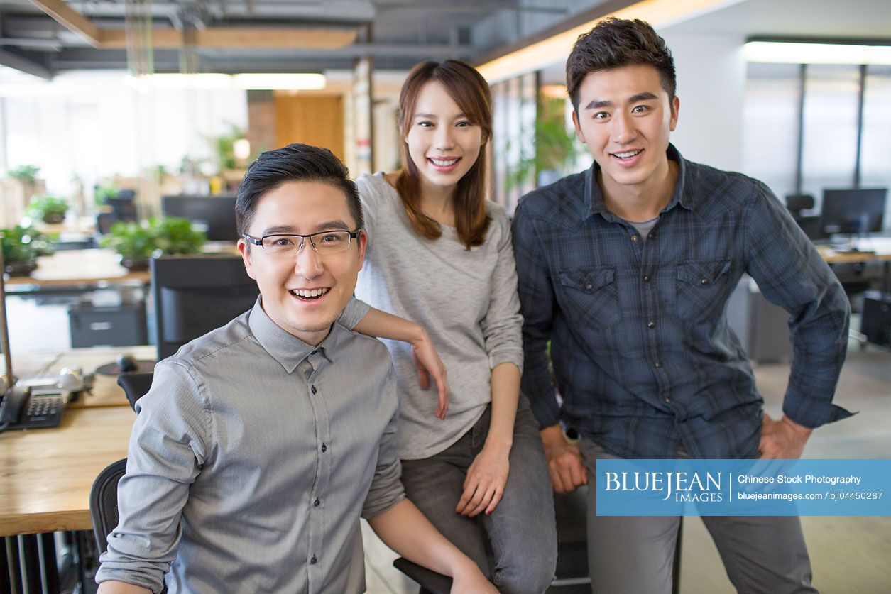 Chinese IT workers standing in office