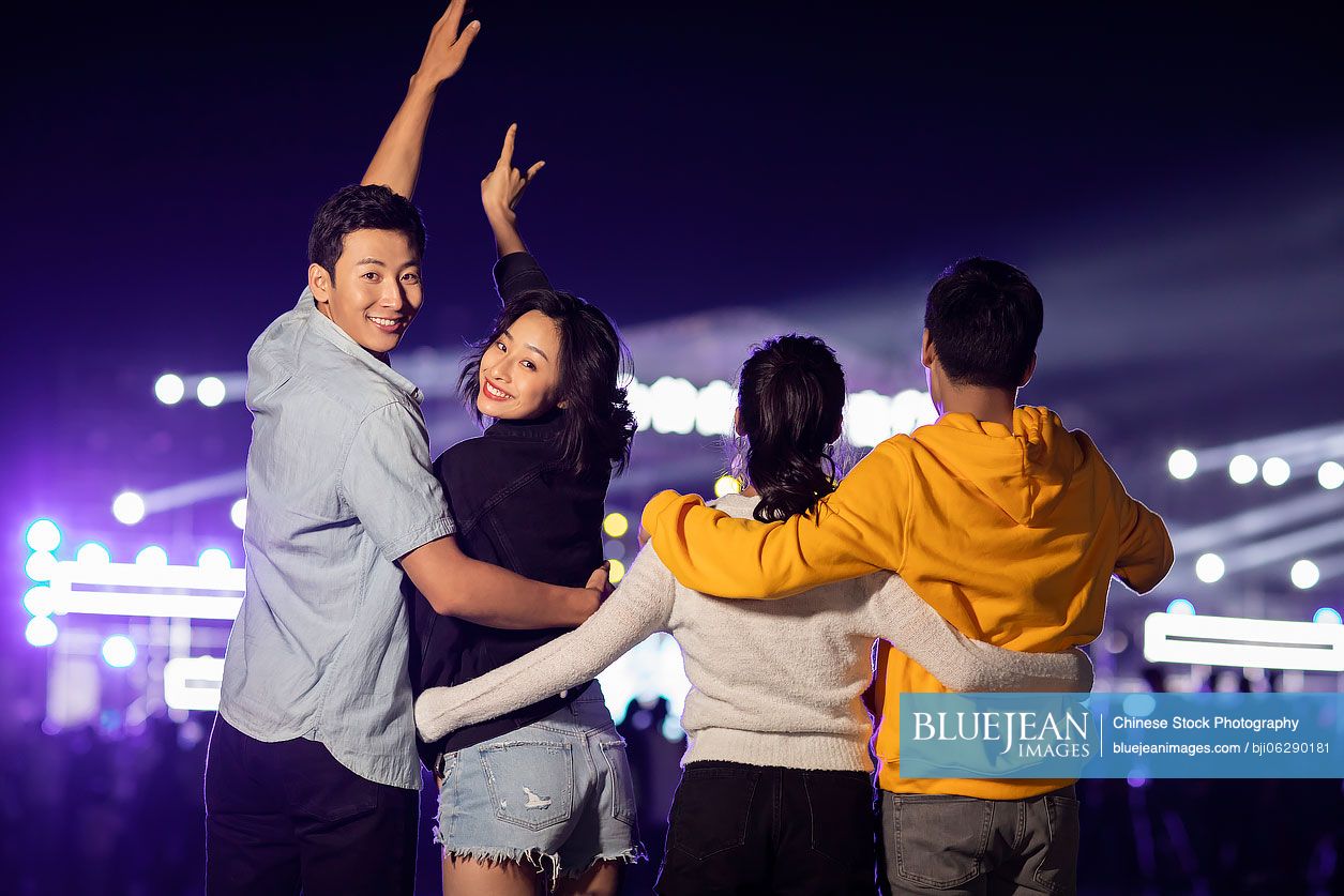 Happy young Chinese friends at music festival