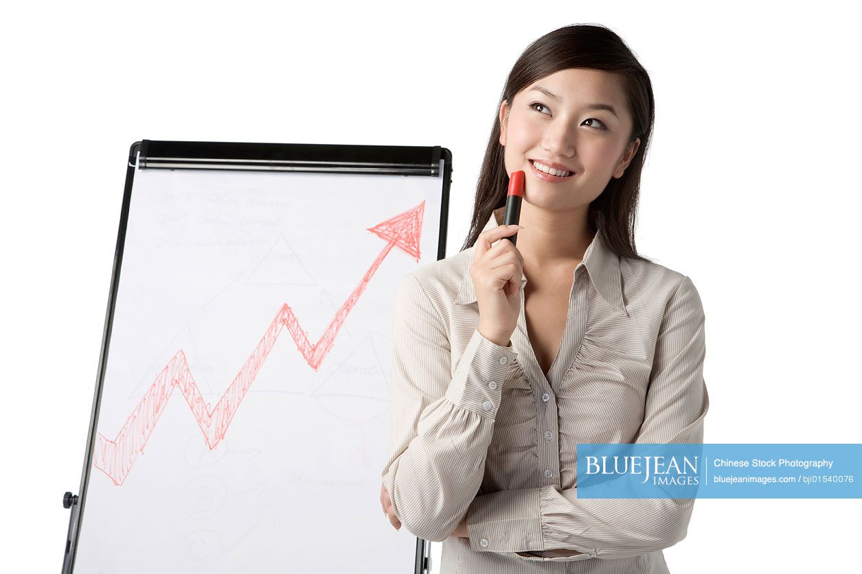 Chinese businesswoman standing by whiteboard