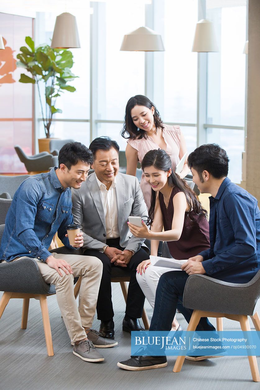 Chinese business people talking in meeting