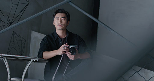 Professional Chinese photographer with digital camera in studio,4K