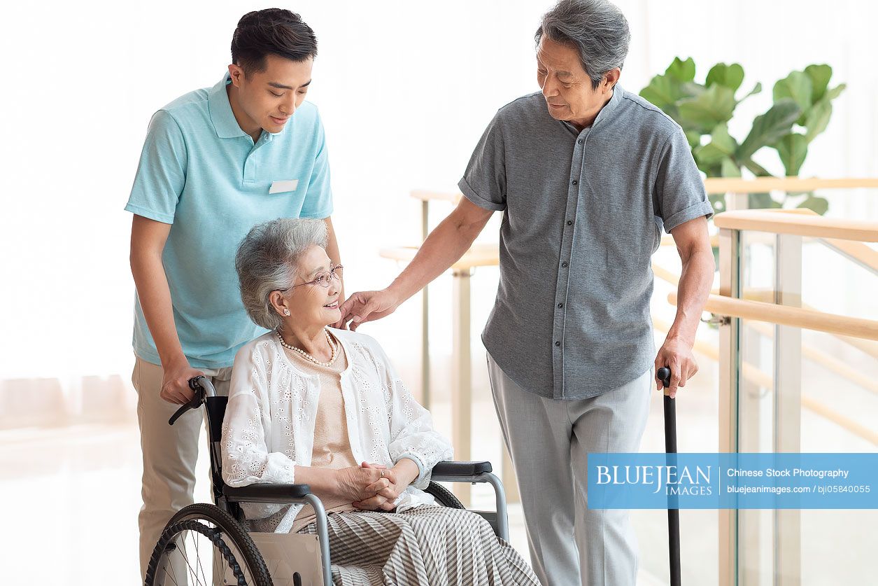Chinese nursing assistant taking care of senior woman